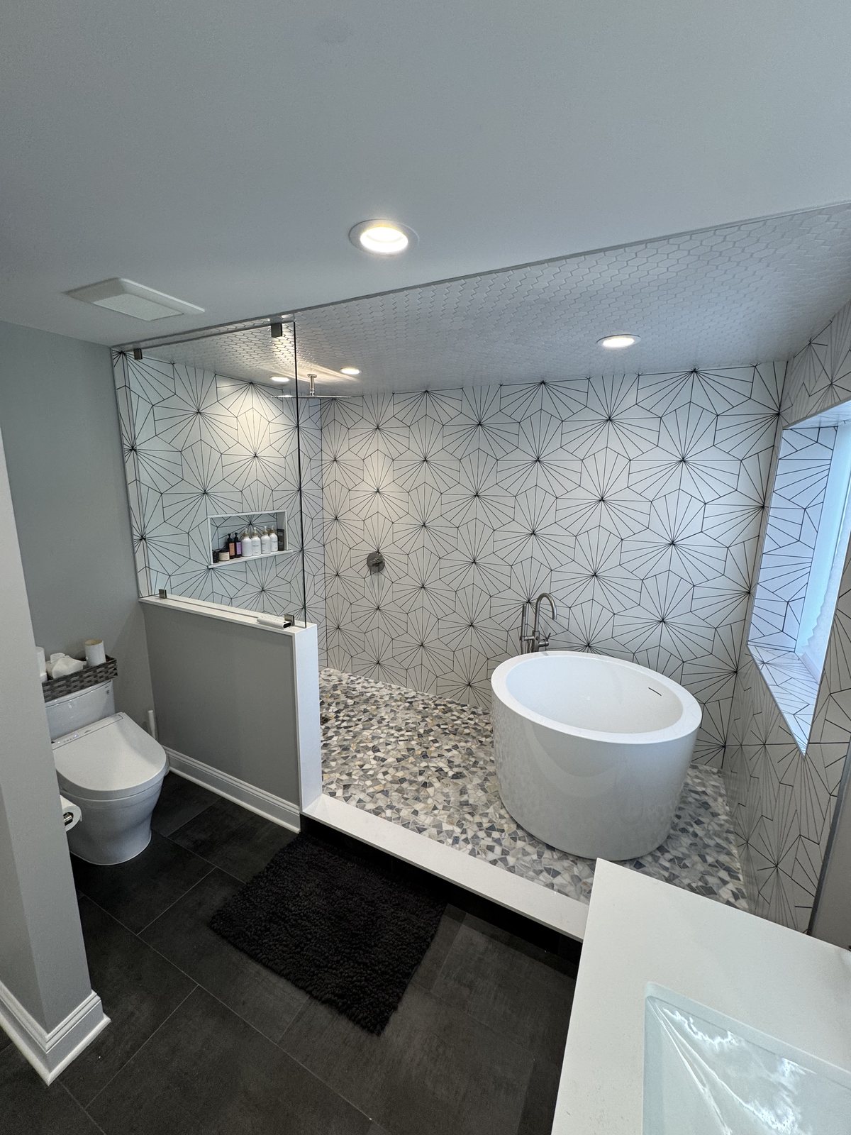 Freestanding tub on marble hex tile